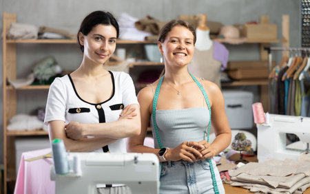 dressmakers are standing in the workshop and smilingの写真素材