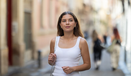 Young woman walking outside on sunny summer dayの写真素材