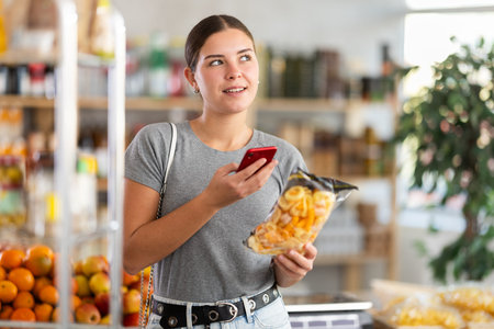 Young woman scanning qr code for snack mix