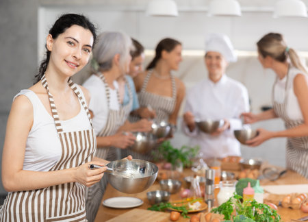Young woman learns to cook at master classの写真素材