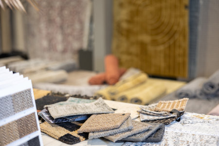 Small pieces and samples of carpets are laid out on table in storeの写真素材