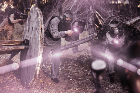 Teams facing on battlefield in outdoor paintball arena during matchの写真素材