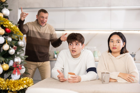 Andult man quarreling with couple of young women and guyの写真素材