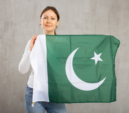 Excited positive girl with Pakistan flag rooting for your favorite teamの写真素材