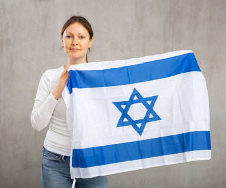 Happy smiling woman proudly displaying israeli flagの写真素材