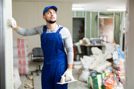 Portrait of a builder in the process of working on a construction site