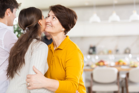 Happy parents welcome their adult son and daughter-in-law at homeの写真素材