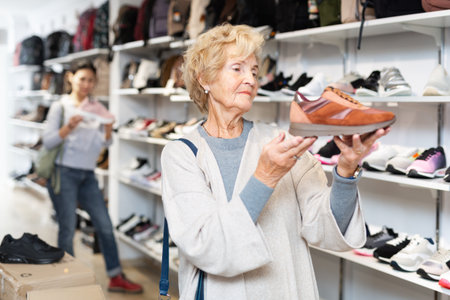 Mature european woman chooses sports sneakersの写真素材