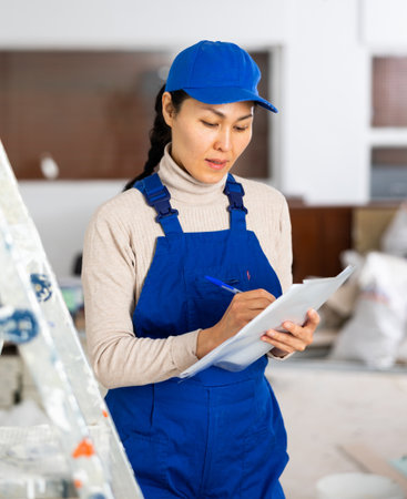 Portrait of an asian builder woman who checks completed work onの写真素材