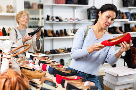 Asian woman buying new footwear in shoe storeの写真素材