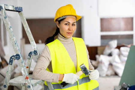 Portrait of Asian woman engineer holding hammerの写真素材