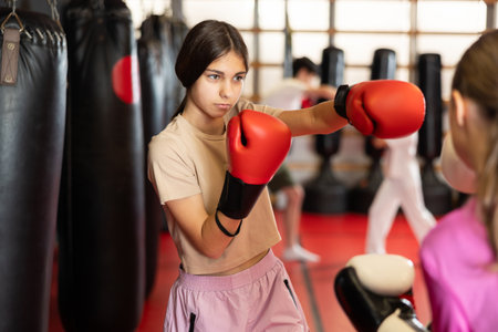 Two teenage girls train boxing in pairsの写真素材