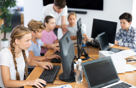 Girl student learning to work on computer in classroomの写真素材