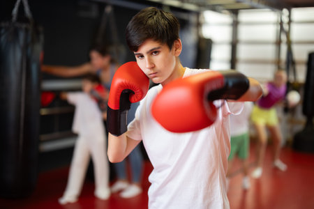 Boy posing during training in boxing glovesの写真素材