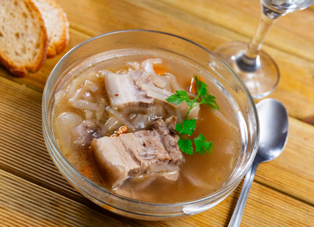 Tasty Russian dish Shchi - sour cabbage soup served in bowlの写真素材
