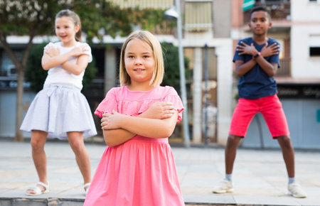 Children exercising contemporary dance moves outdoorsの写真素材