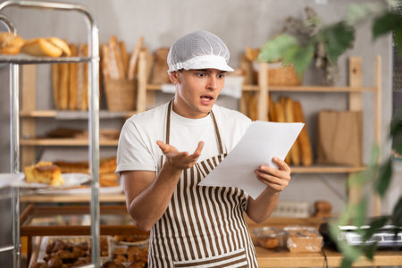 Upset bakery owner shocked by rising utility bills and taxesの写真素材