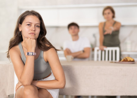 Woman and guy swear at girl. Mom and older brother scold young girl for unsuccessful studies at university. Complex intergenerational relationshipsの写真素材