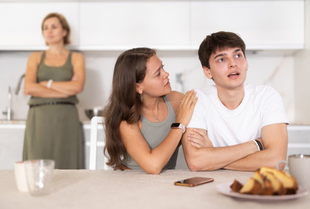 Portrait of thoughtful woman who had conflict with adult children while cooking dinner in kitchenの写真素材