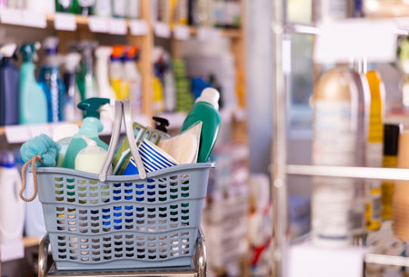 Essential cleaning products and personal care products in shopping basketの写真素材