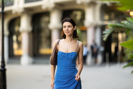 Young woman posing on city streetの写真素材