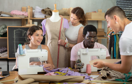 Participants in coterie practice sewing, chatting and talking, work with mannequin