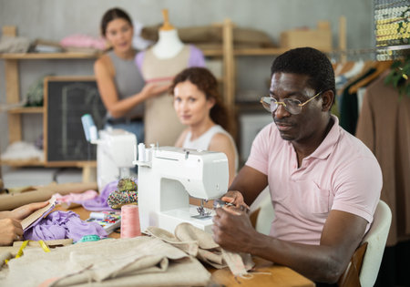 Participants in coterie practice sewing, chatting and talking, work with mannequin