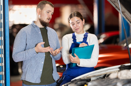 man with a manager in a car serviceの写真素材