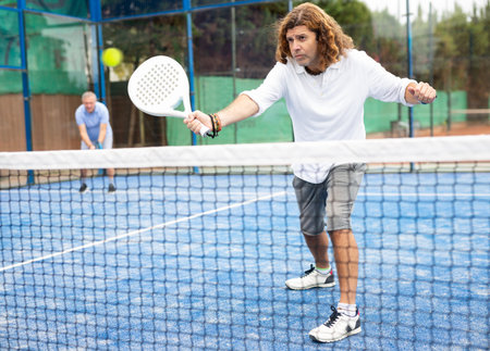 Man training to play tennis on padel court outdoorの写真素材