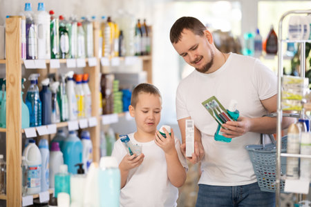 Man and boy choosing dental care productsの写真素材