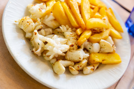 Roasted sepia with fried potatoesの写真素材