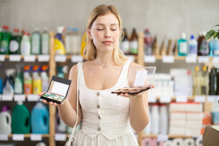 Young woman in summer clothes choosing cosmetics in supermarketの写真素材