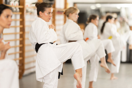 Women practice fighting stances during karateの写真素材
