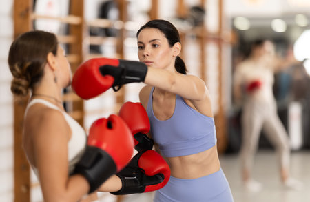 Young women in gym boxing trainingの写真素材