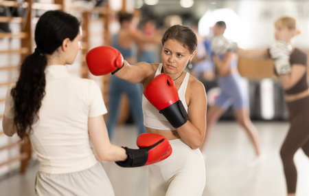 Young women in gym boxing trainingの写真素材