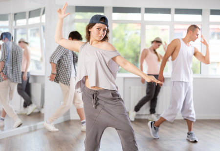 Group of young hip-hop dancers rehearsing in studio. Dancers full of energyの写真素材