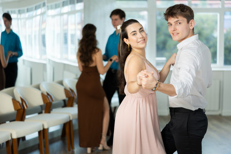 Couple young woman and man dancing ballroom dancingの写真素材