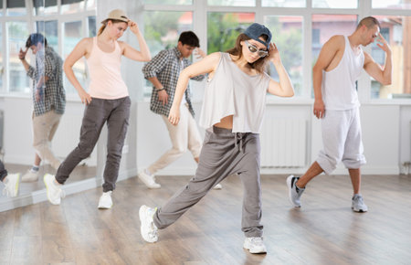 Young girl practicing hip hop slide moves in training hall