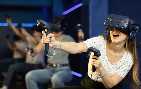 Happy woman is fascinated by movie in virtual reality glasses in room