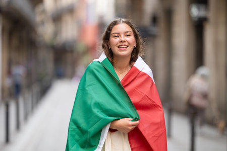 Portrait of woman with Italy flag on street of summer cityの写真素材