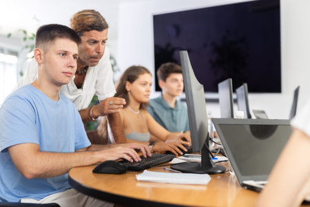 Motivated young trainee developer working at IT startup with mentor