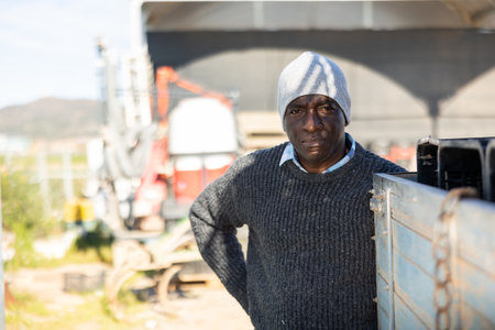 Male tractor driver in farm backyardの写真素材