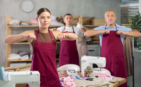 Tailors do a warm-up in the workshopの写真素材