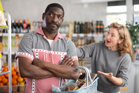 European wife and African husband, yells at each other in shopの写真素材