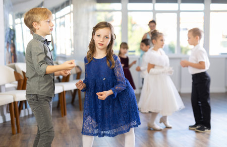 Beautifully dressed little boys and girls dance couple twist dance