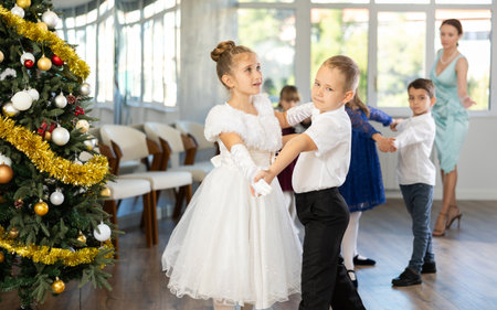 Children rehearsing ballroom dance for upcoming Christmas party at schoolの写真素材