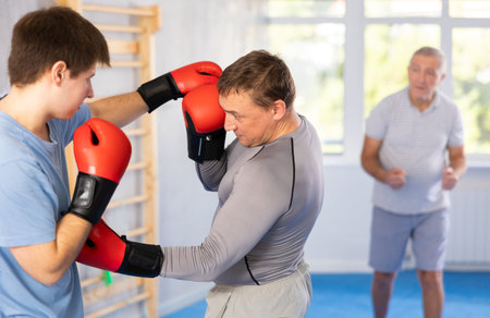 Two men training boxing fight in studio