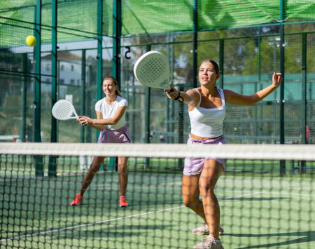 Two women tennis players playing padelの写真素材