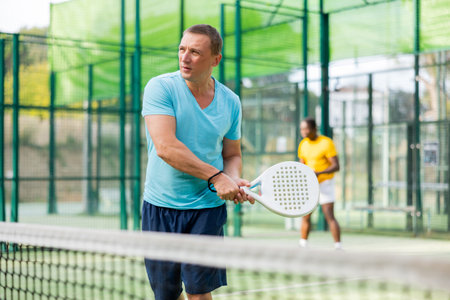 Man training to play tennis on padel court outdoorの写真素材