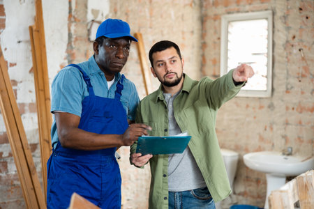 African american builder signs documents from the engineerの写真素材